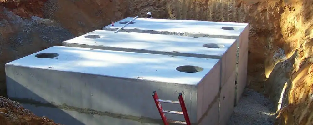 Septic tank installation site with a newly placed concrete tank in Greenville, NC